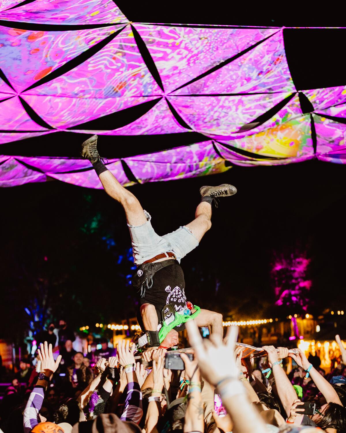 A fan, shown upside down, crowd surfing at Desert Daze music festival.