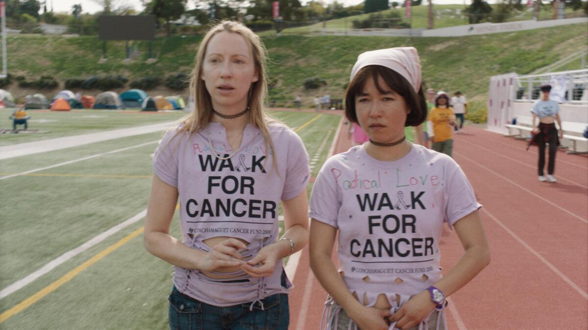 Two girls participate in a walk for cancer.