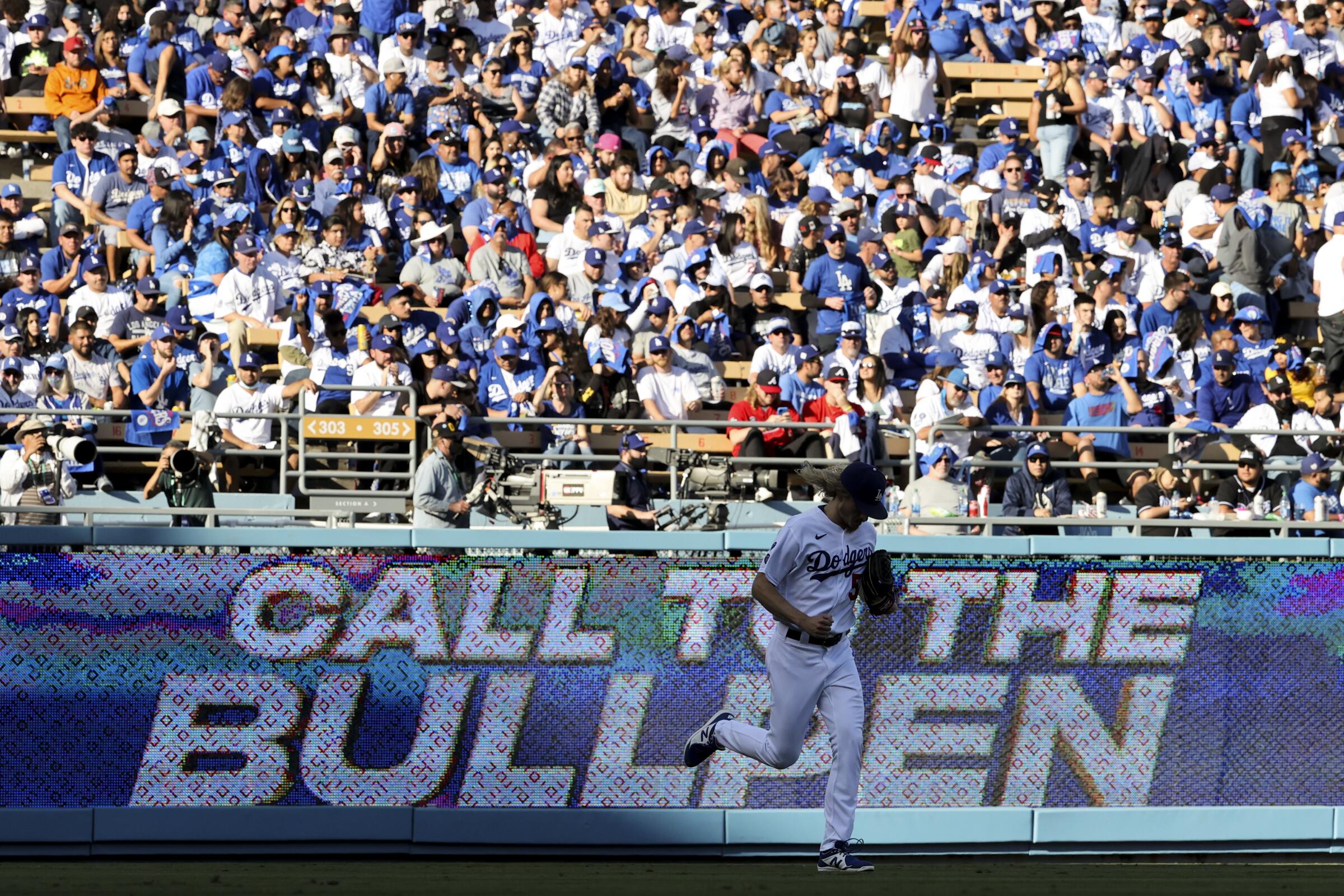 Dodgers reliever Phil Bickford runs onto the field.