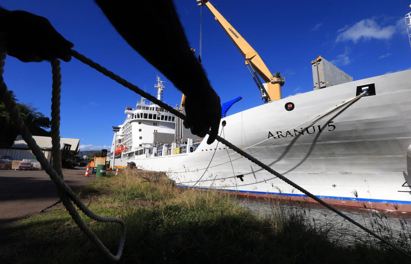 A crewman pulls a line on Hiva Oa, one of the Marquesas Islands. The Aranui 5 is a half cargo, half cruise ship.
