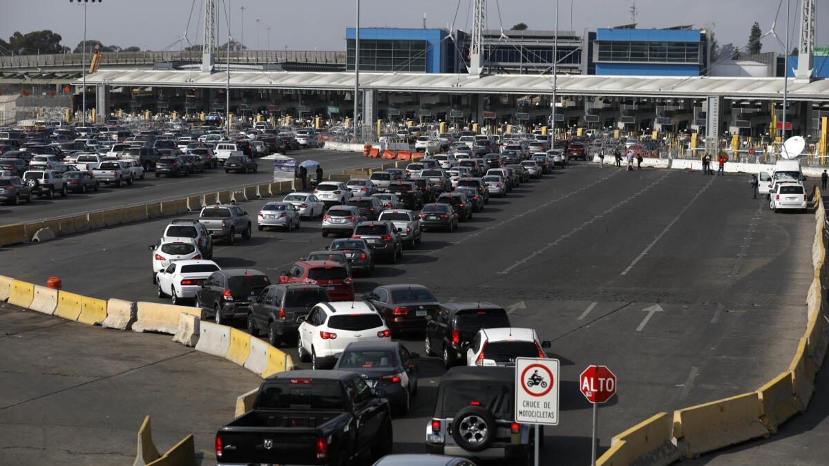 U.S. Customs and Border Protection officials increase their presence along the San Ysidro Port of Entry on Nov. 19, where concertina wire and cement barriers were added.