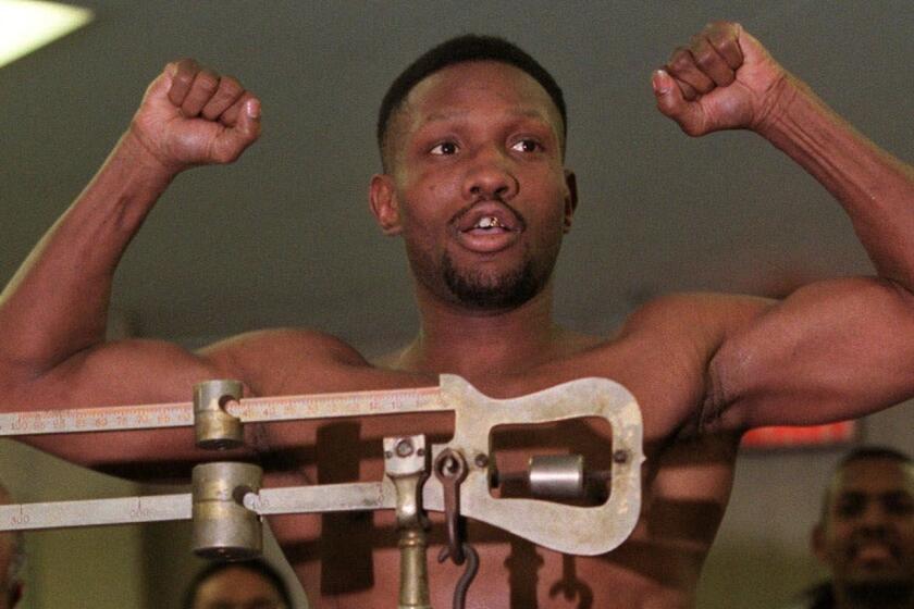 Pernell Whitaker flexes his muscles Friday, Feb. 19, 1999, during the weigh-in for his fight against fellow welterweight Felix Trinidad in New York. The showdown between Whitaker and Trinidad at New York's Madison Square Garden, is set for Saturday, Feb. 20, 1999. (AP Photo/Suzanne Plunkett) ORG XMIT: NYR118