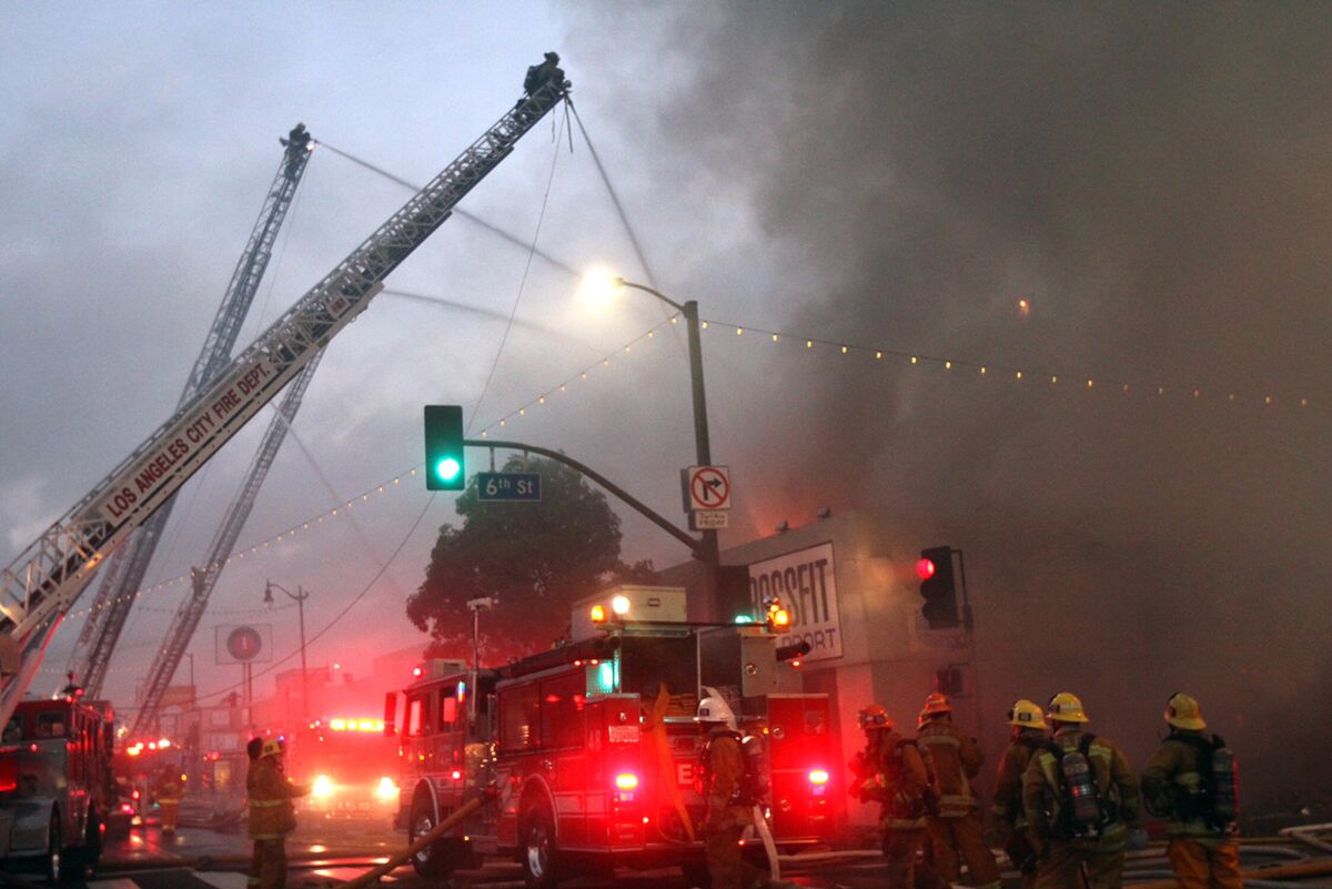 Firefighters at the scene at Pacific Avenue and 6th Street in San Pedro, where a business was on fire on Monday.