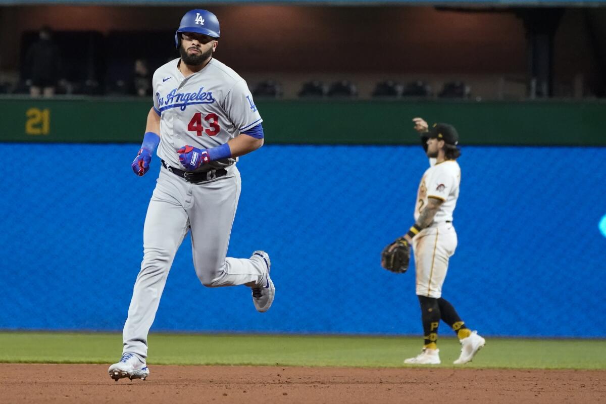 Dodgers' Edwin Rios rounds second past Pittsburgh Pirates second baseman Michael Chavis after hitting a home run.