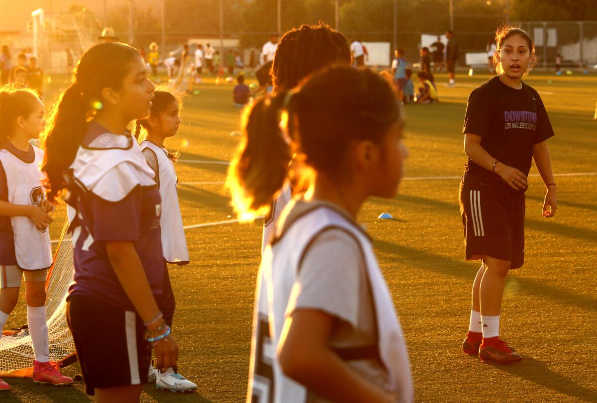LOS ANGELES, CA - JULY 26, 2023 - Nayelli Barahona, right, coaches youngsters with Downtown LA Soccer Club.