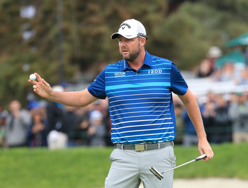 Marc Leishman reacts after sinking his putt on the 18th green during the final round of the Farmers Insurance Open at Torrey Pines on Sunday.