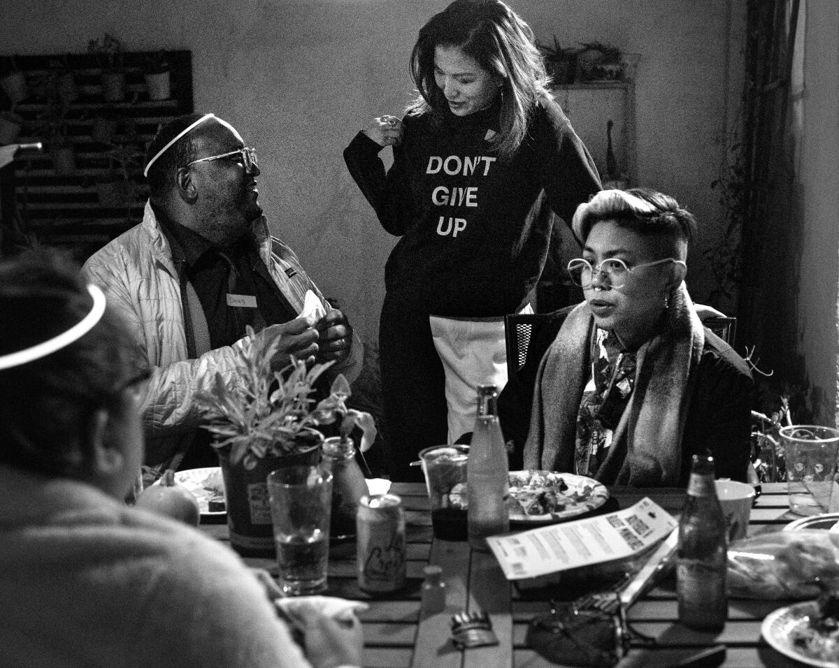  Jean Chen Ho, center,  talks with fellow writers seated at a table