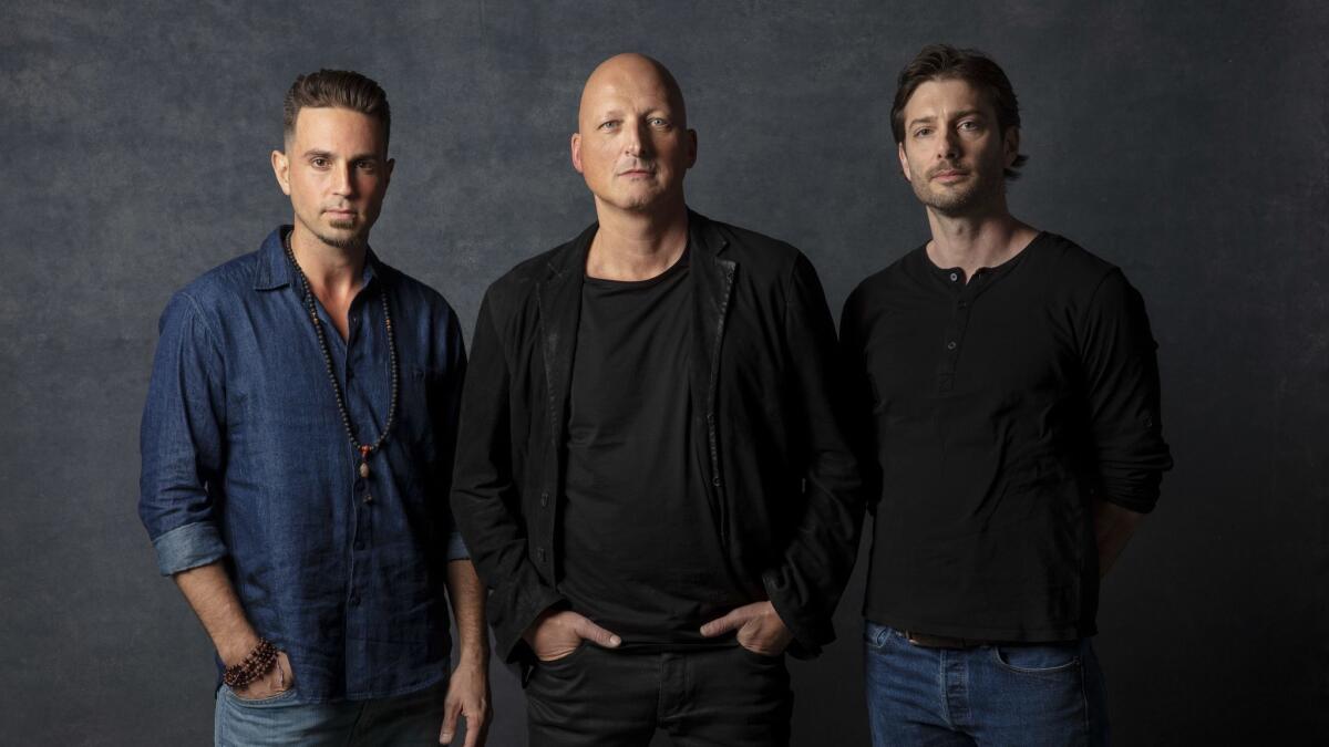 "Leaving Neverland" director Dan Reed, center, with subjects Wade Robson, left, and James Safechuck photographed in the L.A. Times Photo and Video Studio at the 2019 Sundance Film Festival, in Park City, Utah.