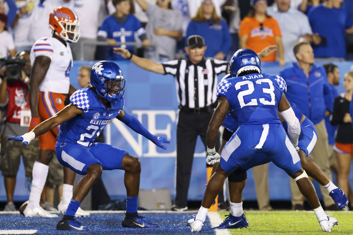 Kentucky's defense celebrates after stopping Florida on a fourth down to win their NCAA college football game in Lexington, Ky., Saturday, Oct. 2, 2021. (AP Photo/Michael Clubb)