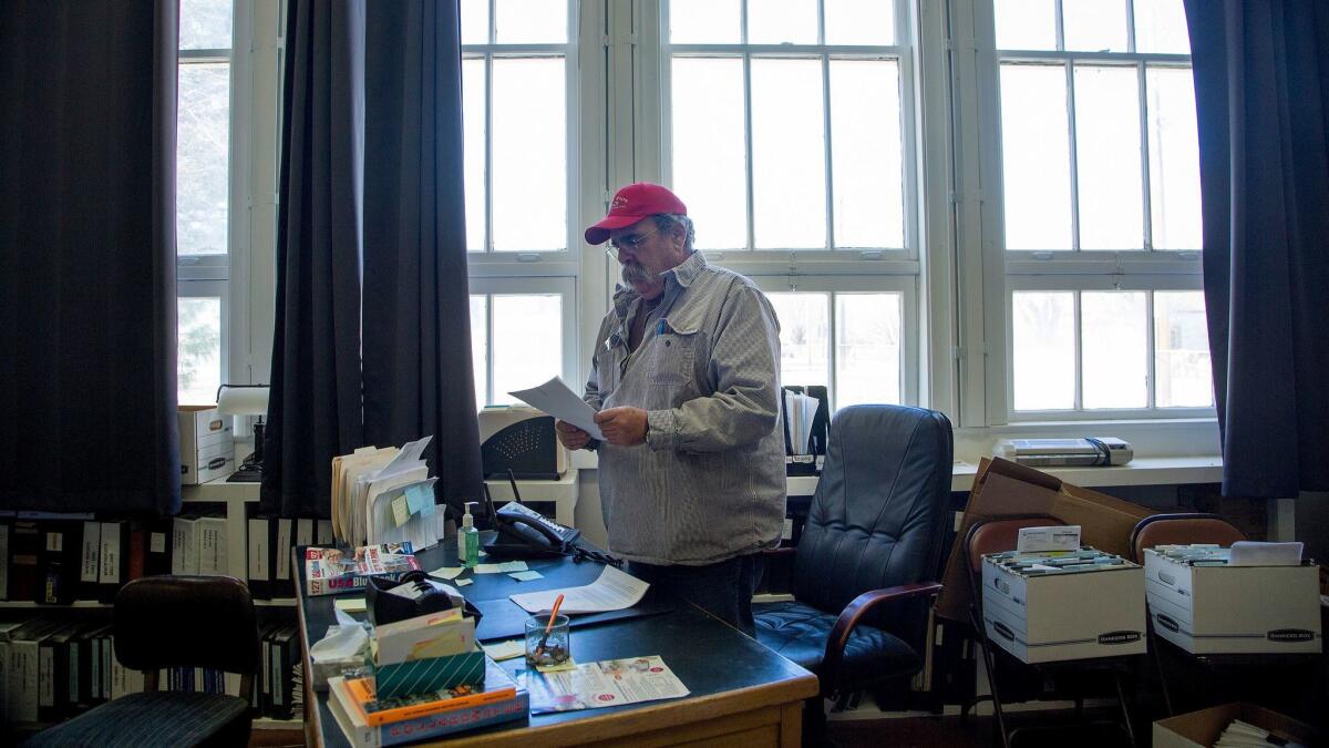 Loyalton Mayor Mark Marin, at his City Hall desk, has the job of sorting through the budget mess he inherited — including the city opting out of the state pension fund. (Myung J. Chun / Los Angeles Times)