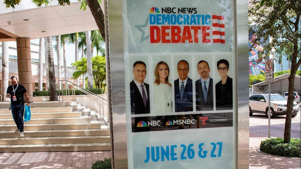 Posters are seen on the side of the Adrienne Arsht Center for Performing Arts in Miami, Florida, on June 25.