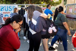 Redondo Beach, CA - December 05: Families hugged kids after signing them out to take home from Redondo Union High School, after the school was on "lockdown," because of a report of a student with a gun, in Redondo Beach, CA, Tuesday, Dec. 5, 2023. This large police response and security threat, which resulted in another teen being lead away in handcuffs, comes the day after a student was arrested for bringing a loaded, high-capacity hand gun onto campus. (Jay L. Clendenin / Los Angeles Times)