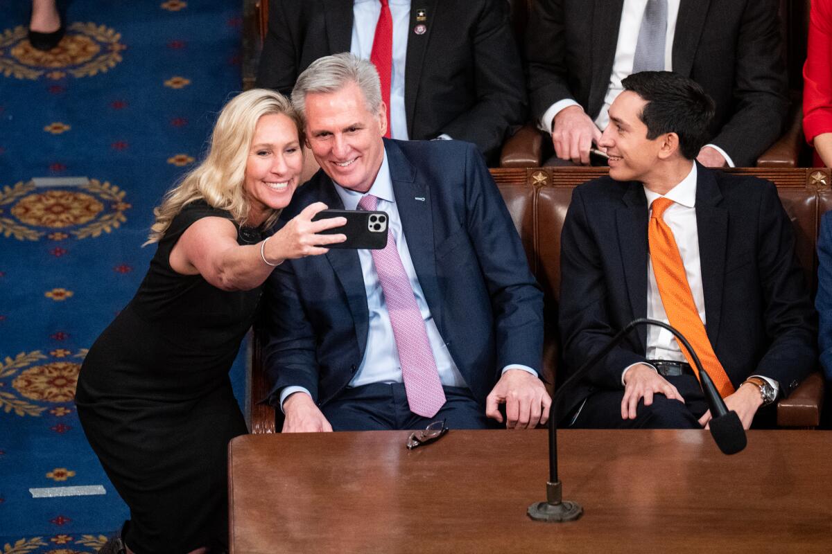 Rep. Marjorie Taylor Greene snaps a photo with Rep. Kevin McCarthy after the 15th round of voting for speaker on Jan. 7. 