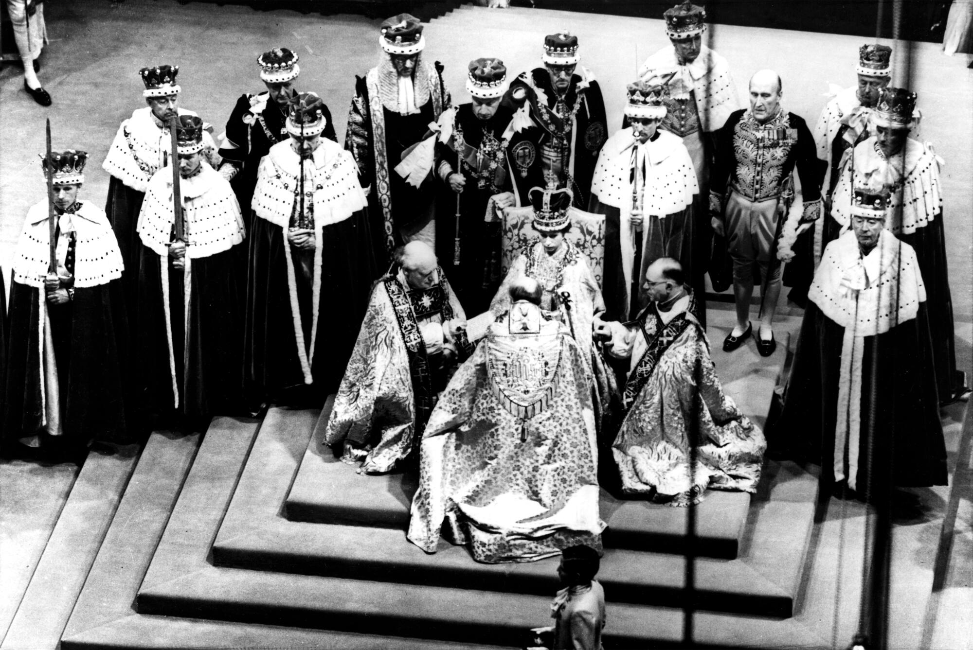 Three men in robes kneel around a woman wearing a crown and seated on a raised platform. Behind her are men in robes 