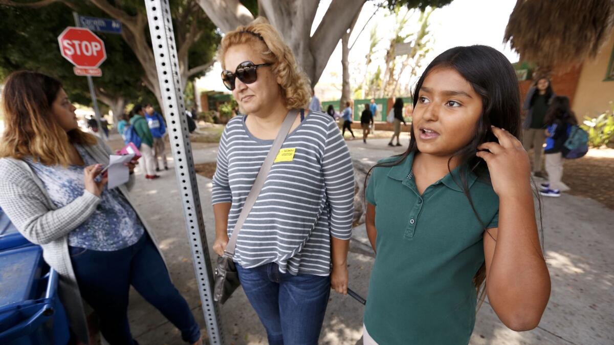 Webster Middle School sixth-grader Julieann Gonzalez, 11, right, with her mother, Angela Rodriguez, middle.