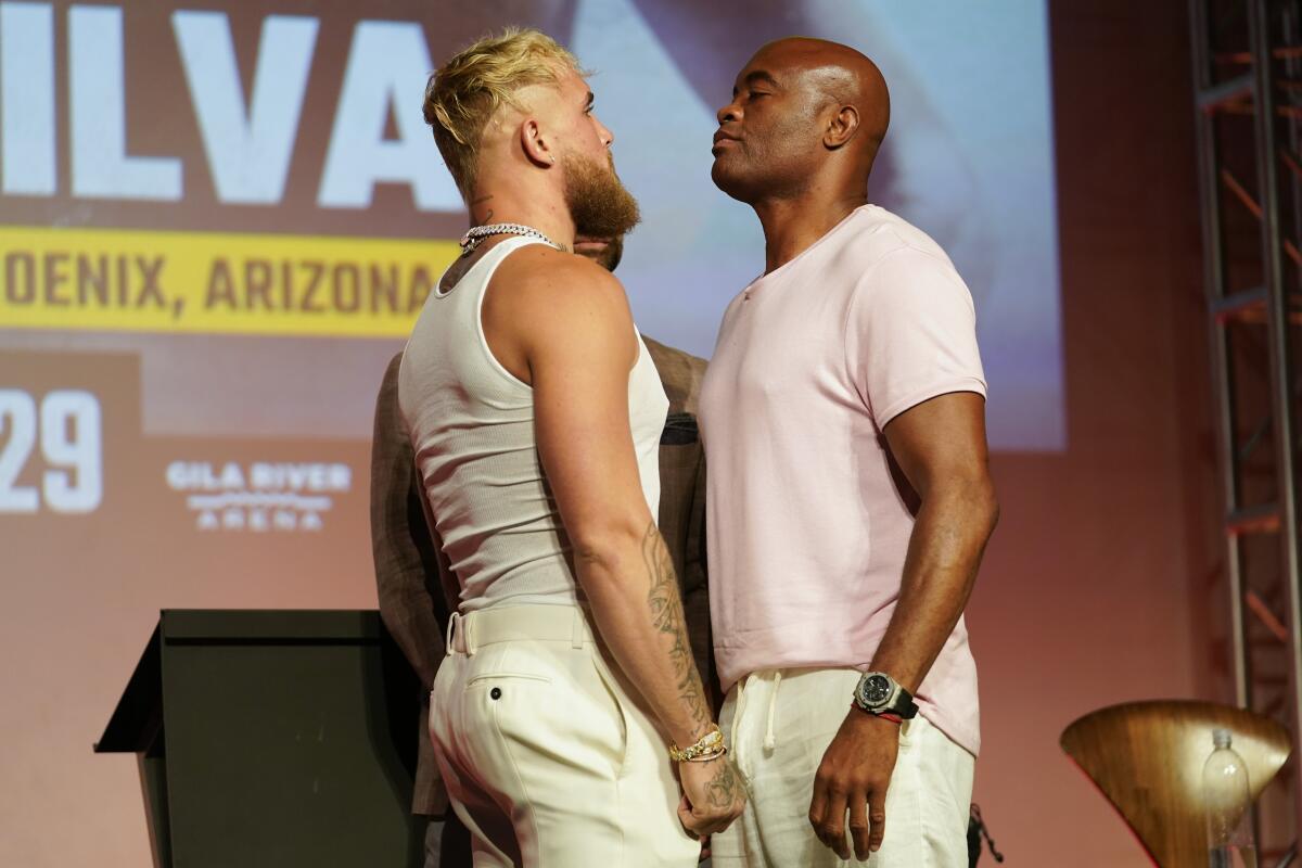 Jake Paul, left, and Anderson Silva meet during a ne 