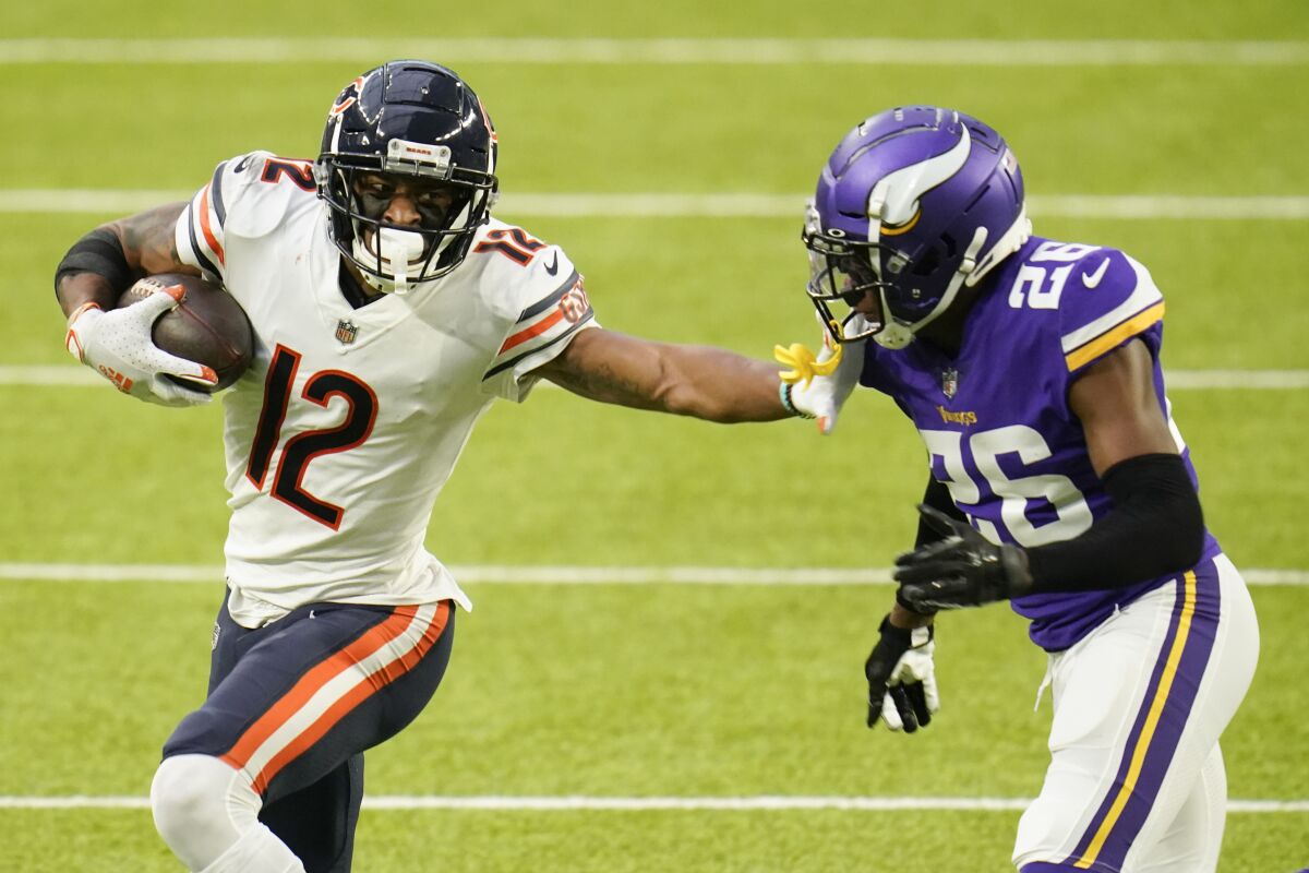 Chicago Bears receiver Allen Robinson, left, pushes Minnesota Vikings cornerback Chris Jones away after catching a pass