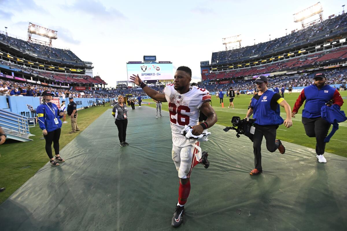 New York Giants running back Saquon Barkley (26) celebrates after the Giants defeated the Tennessee Titans 21-20 in an NFL football game Sunday, Sept. 11, 2022, in Nashville. (AP Photo/Mark Zaleski)