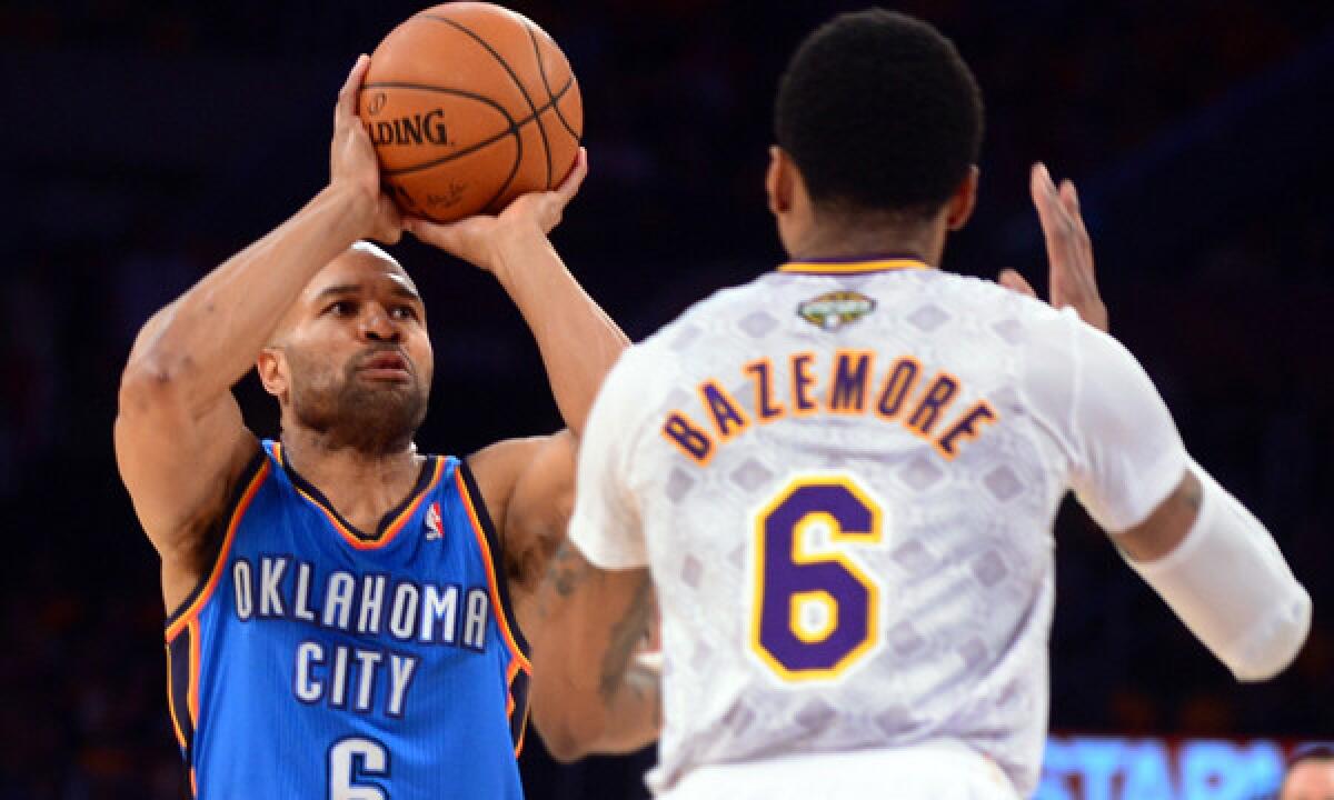 Oklahoma City Thunder point guard Derek Fisher, left, shoots over Lakers guard Kent Bazemore during the Lakers' 114-110 win Sunday at Staples Center.