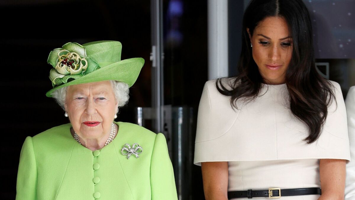 Queen Elizabeth II, dressed in the adopted color of remembrance, and Meghan, Duchess of Sussex, observe a moment of silence in memory of the victims of the Grenfell Tower fire.