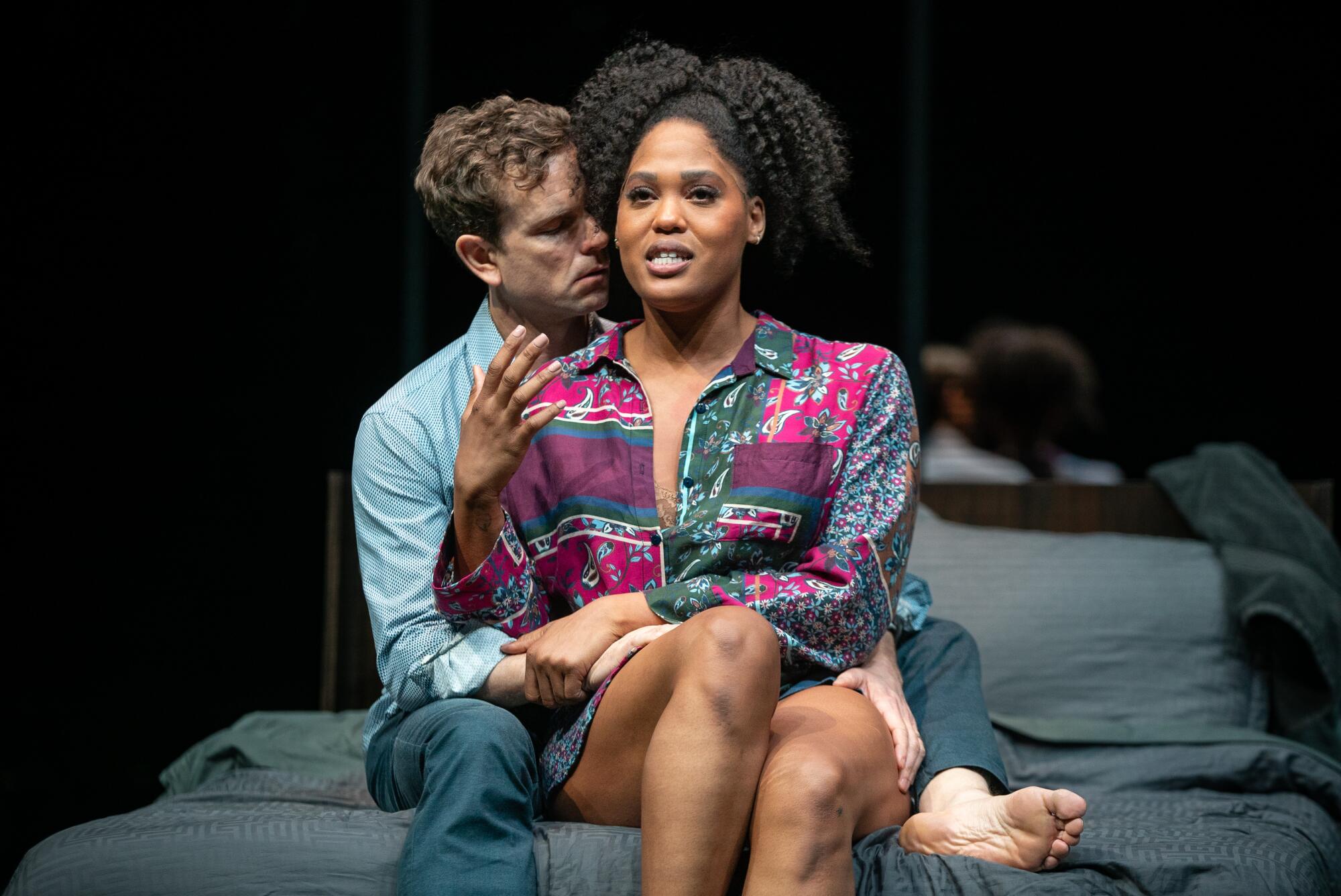 A man wraps his body around a woman in "Slave Play."