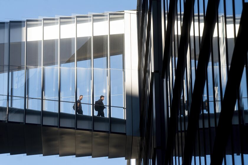 Workers cross a skybridge at Twitter's San Francisco offices on Tuesday, Nov. 1, 2022. (AP Photo/Noah Berger)