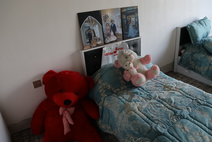 Teddy bears and photos of her betrothed are left behind by Maryam Nouri, who perished this week in an attempt to reach the United Kingdom, in her bedroom of the family home, in the town of Soran in the Kurdish semi-autonomous region of northern Iraq, Sunday, Nov. 28, 2021. Nouri, called Baran by her friends and family, drowned this week along with at least 26 others in the English Channel as she was trying to make the illegal crossing to reunite with her fiancée in the United Kingdom. (AP Photo/Hussein Ibrahim)