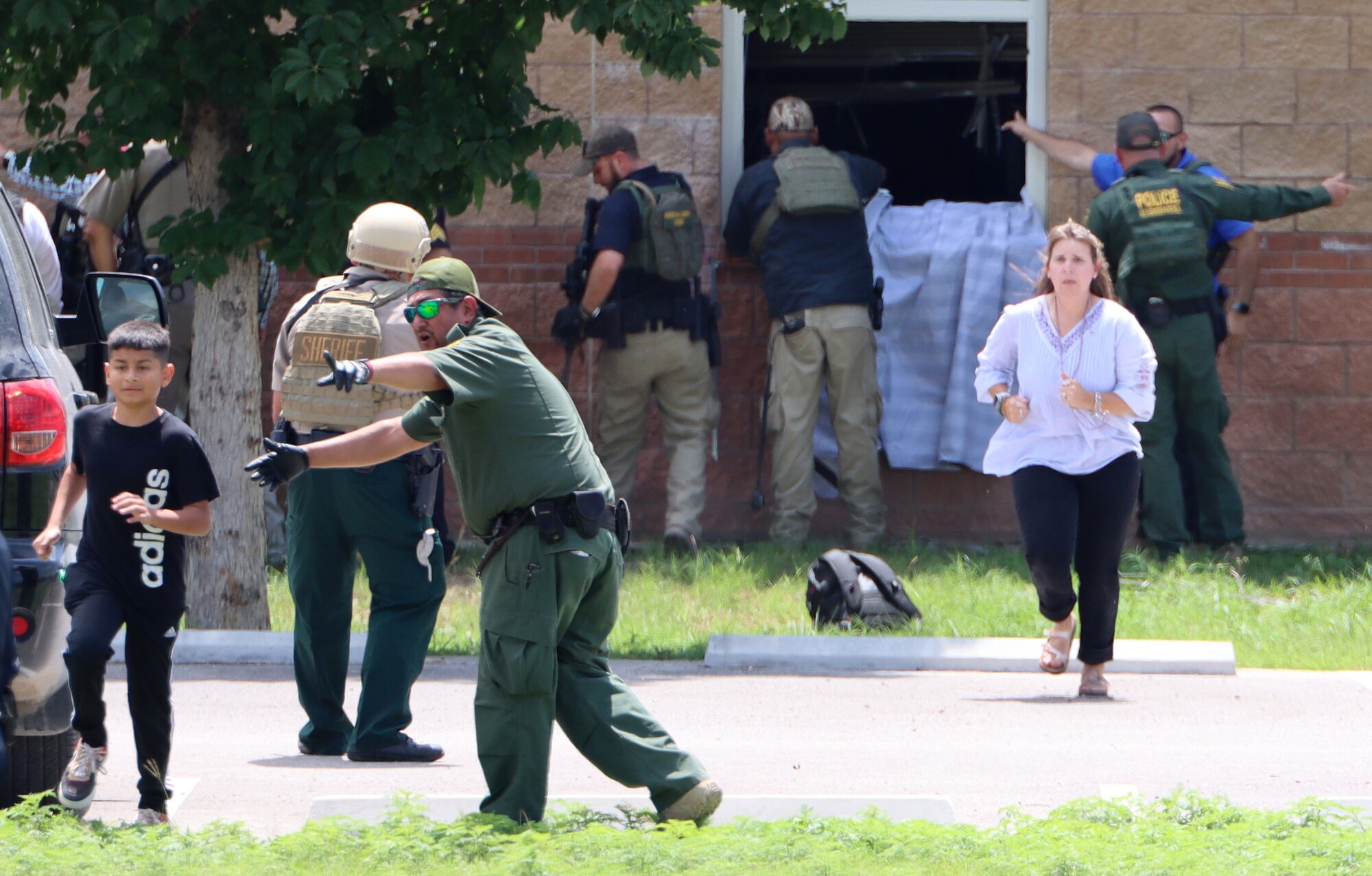 Emergency personnel direct children away from Robb Elementary School on the day of the shooting in Uvalde, Texas.