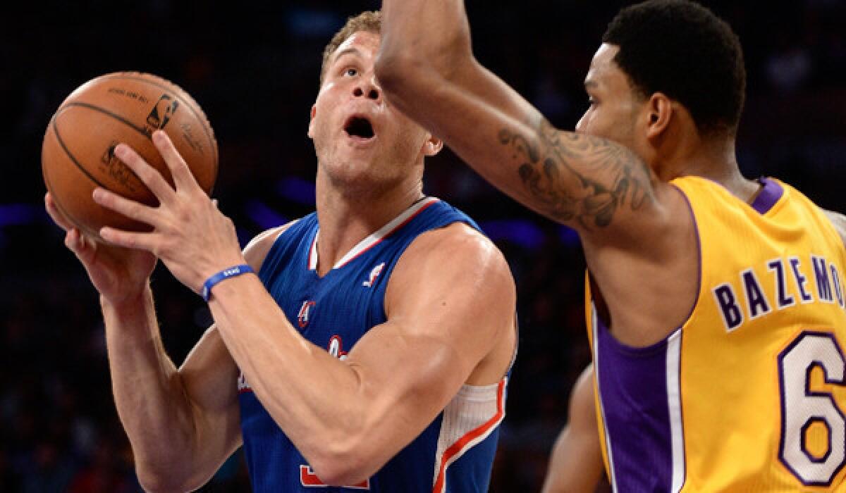 Lakers' Kent Bazemore guards Clippers' Blake Griffin last month at Staples Center.