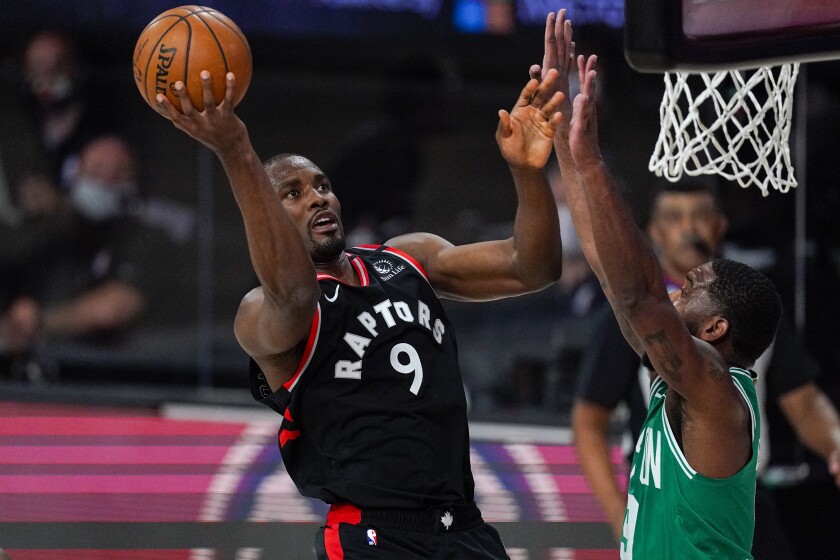 Toronto Raptors center Serge Ibaka shoots over Boston Celtics guard Brad Wanamaker.