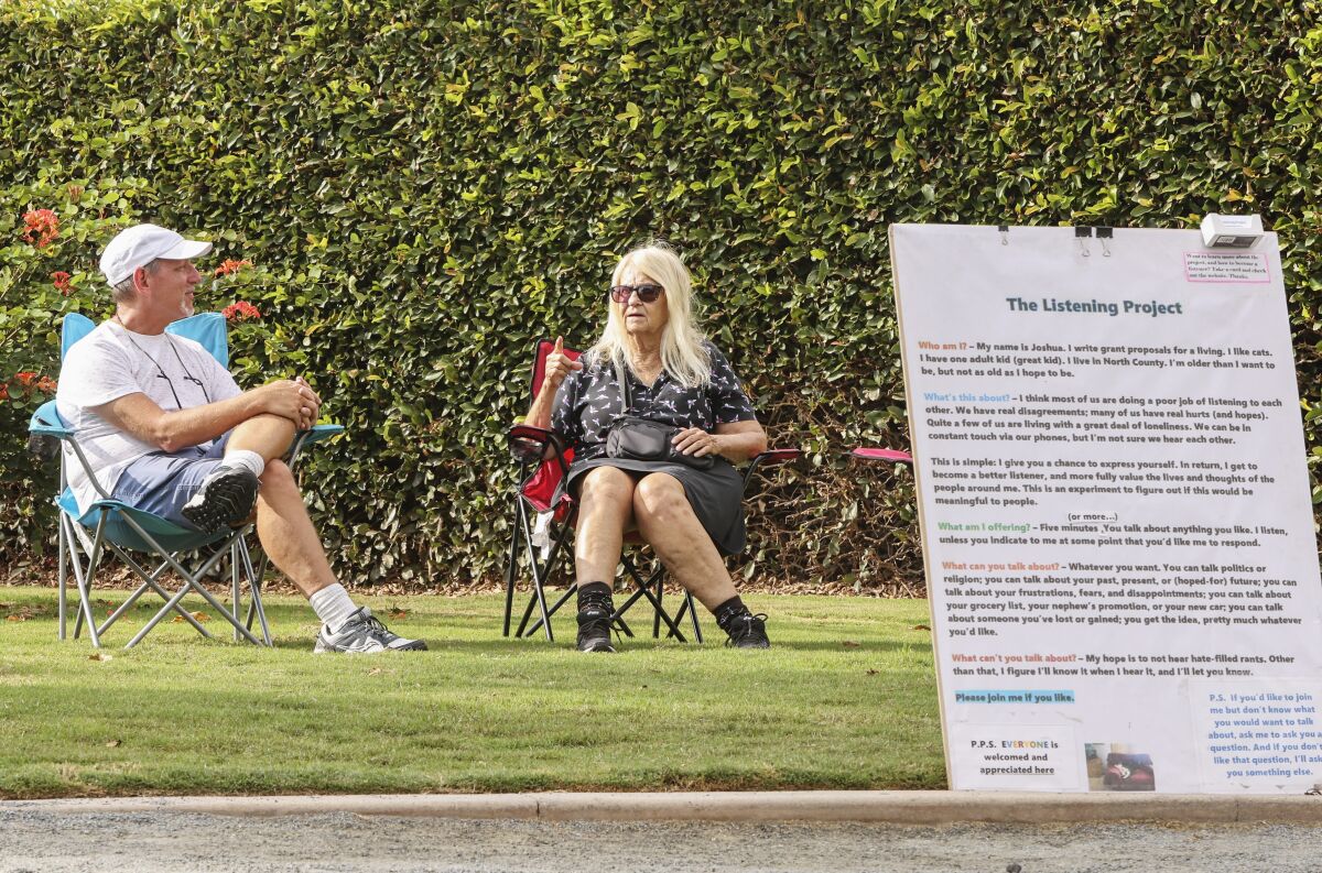 Joshua Lazerson, left, listens to Sara Ohara talk in Swami's Seaside Park.
