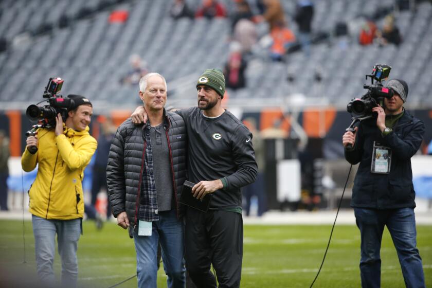 Green Bay Packers' Aaron Rodgers, right, talk to ESPN's Kenny Mayne before an NFL football game against the Chicago Bears, Sunday, Nov. 12, 2017, in Chicago. (AP Photo/Charles Rex Arbogast)