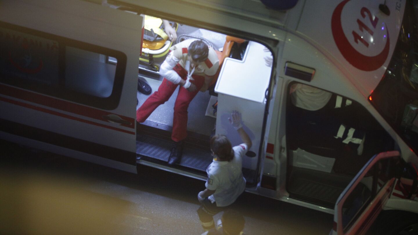 An injured person sits in an ambulance outside Istanbul's Ataturk Airport.