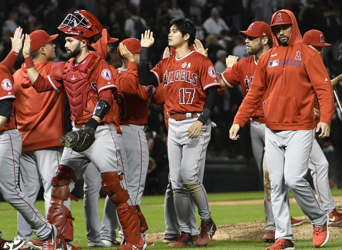 Shohei Ohtani (17) celebrates with teammates after the Angels' 8-7 win against the White Sox on Sept. 7, 2019.