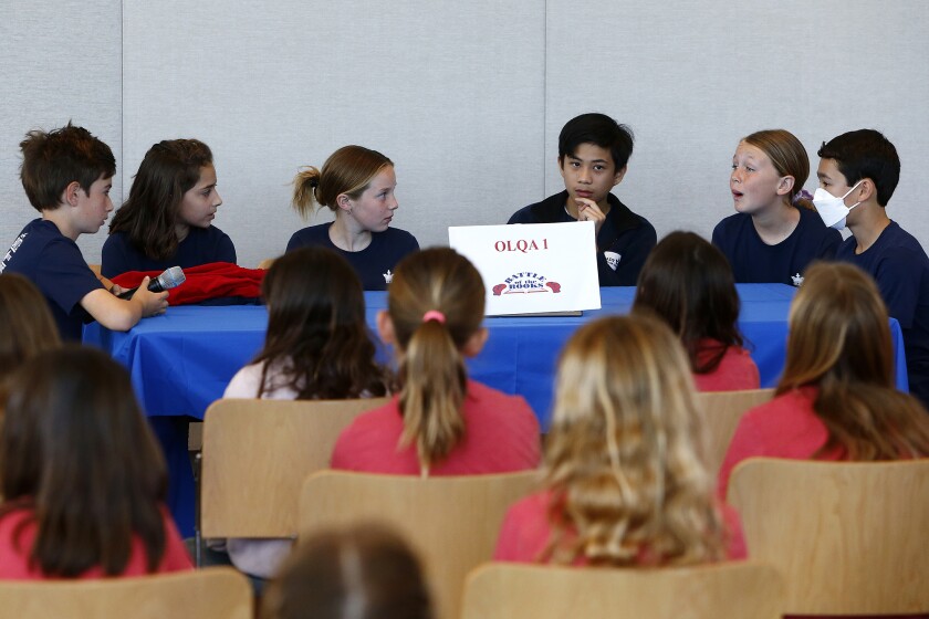 OLQA 1 team members ponder an answer in Round 1 against Eastbluff 2.