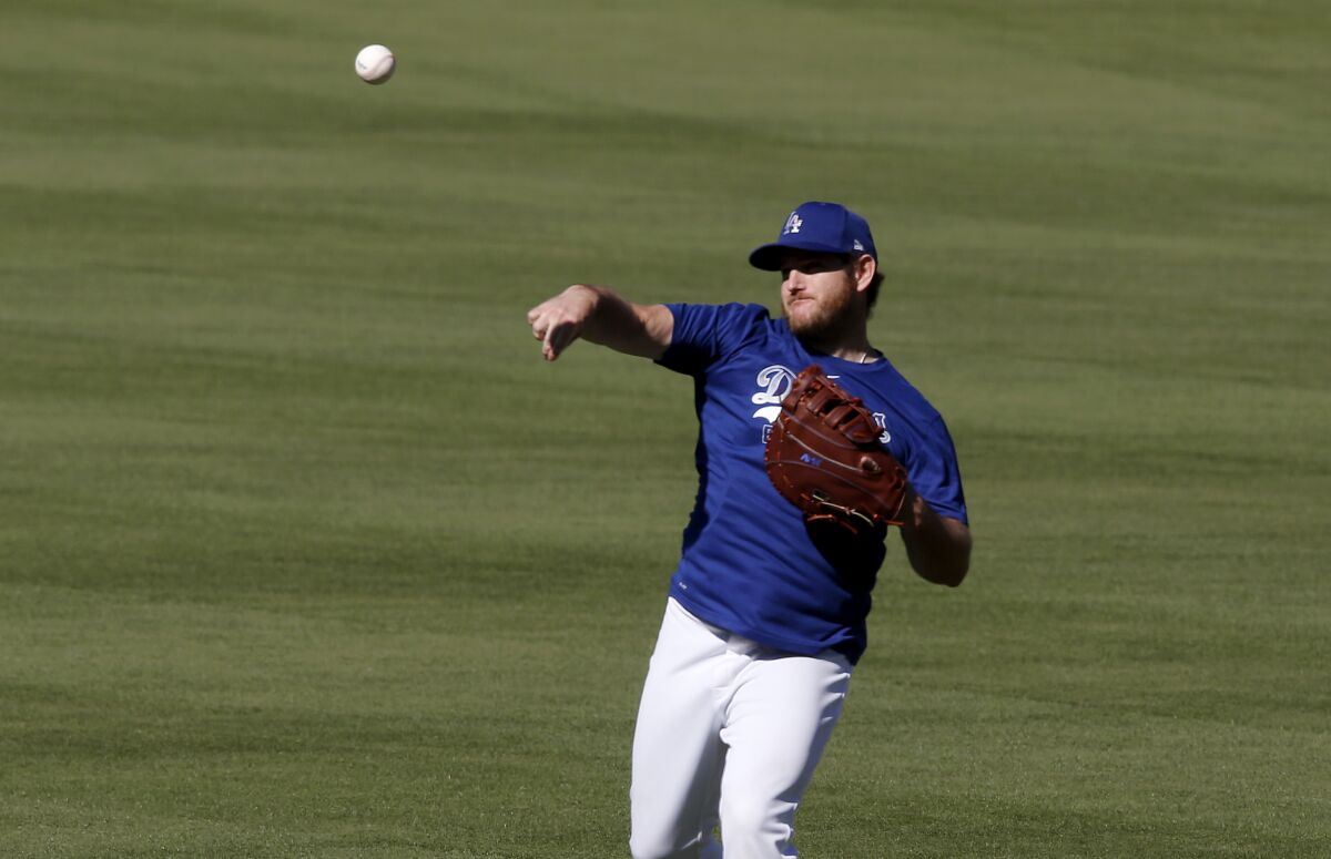 Dodgers first baseman Max Muncy warms up during practice at Dodger Stadium on July 3.