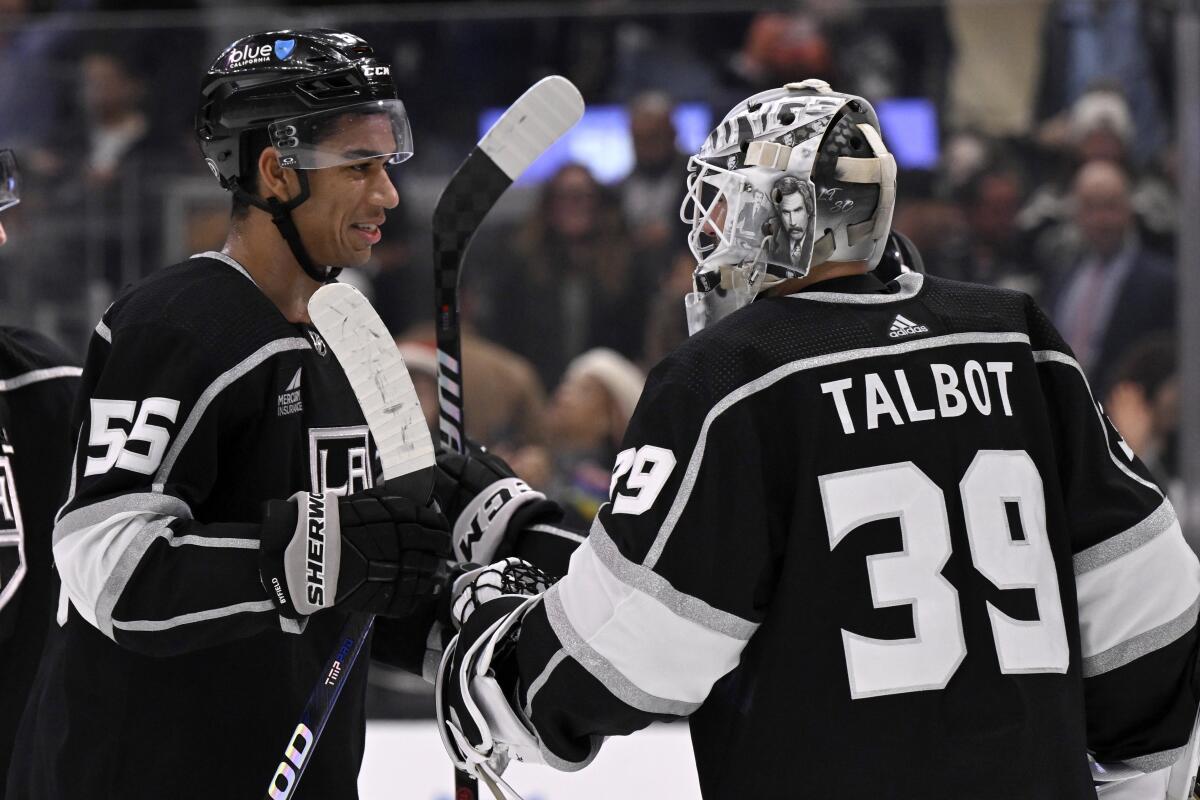 Kings forward Quinton Byfield celebrates with goaltender Cam Talbot after a 5-3 win over the Calgary Flames.
