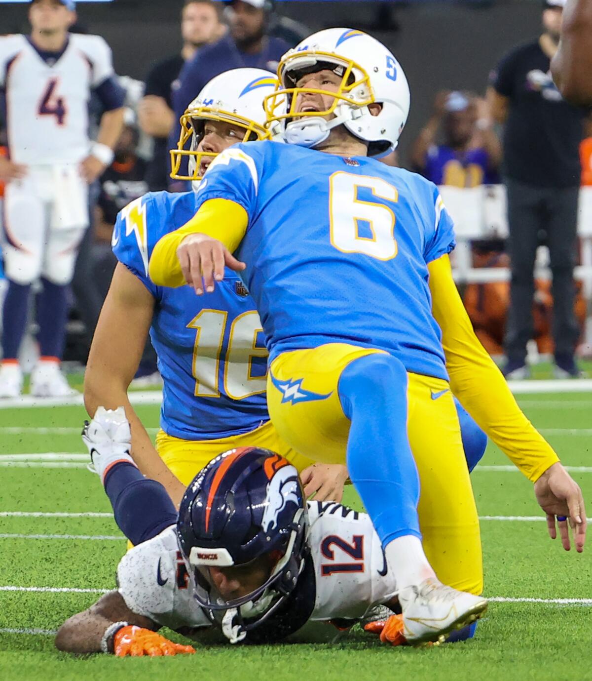 Injured Chargers kicker Dustin Hopkins (6) grimaces after making a game-winning field goal in overtime.