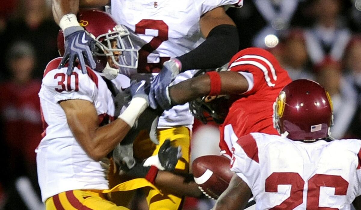 USC cornerback Brian Baucham (30) and safety Taylor Mays (2) break up a pass intended for Ohio State's DeVier Posey during a game in 2009.