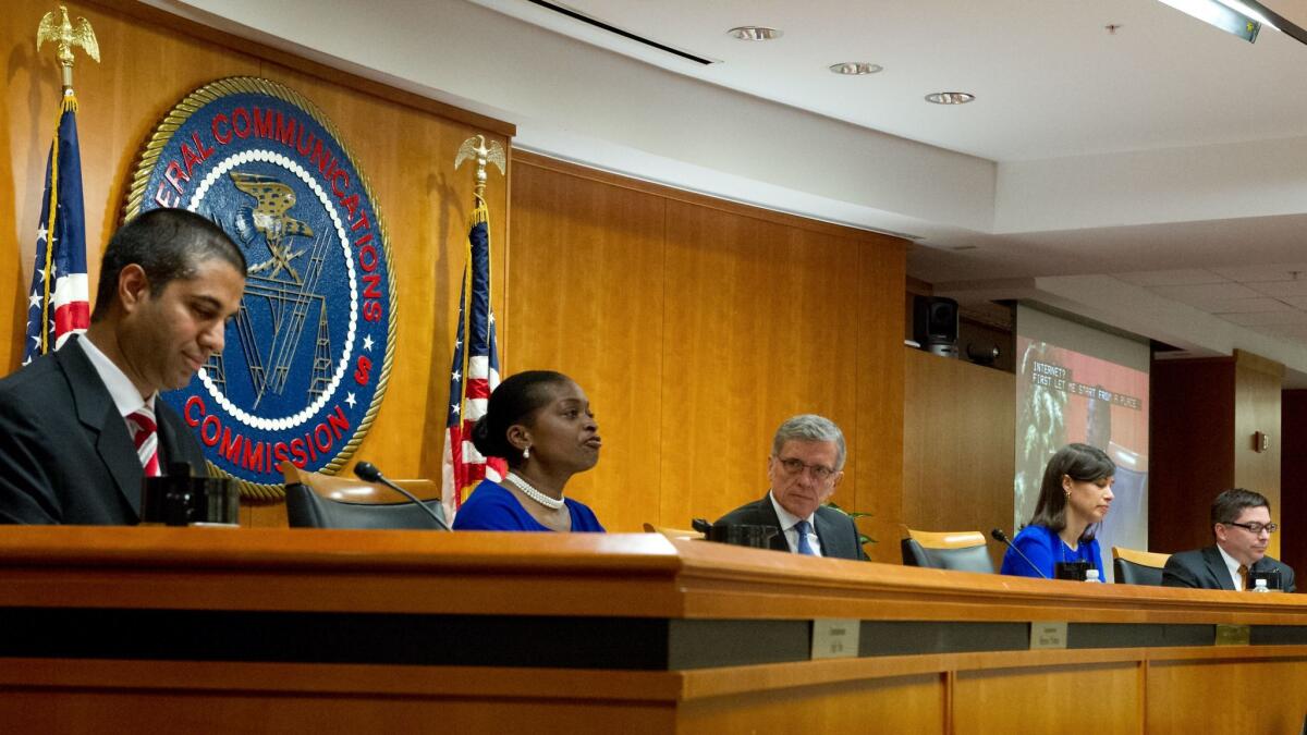 Commissioner Ajit Pai of the Federal Communications Commission, left, attends a meeting on net neutrality rules proposed by Chairman Tom Wheeler, center. Also pictured are commissioners Mignon Clyburn, second from left, Jessica Rosenworcel and Michael O'Rielly. Pai opposes neutrality rules.