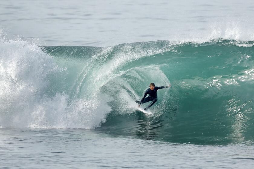 David Dupont rides a wave in La Jolla as high surf pounded the San Diego coast on Jan. 16, 2018. (Photo by K.C. Alfred/ San Diego Union-Tribune)