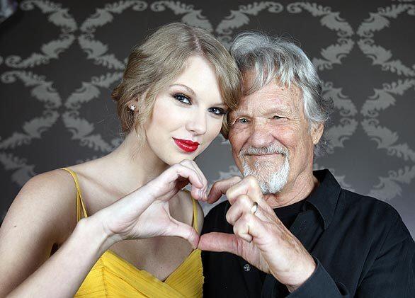 Country singers Taylor Swift and Kris Kristofferson show their love before the concert.