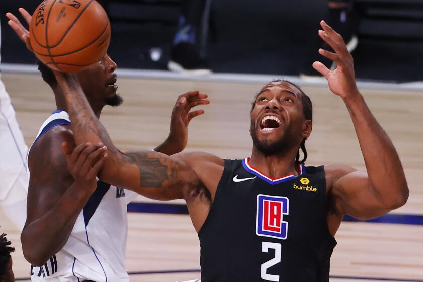 Los Angeles Clippers' Kawhi Leonard (2) loses a rebound against Dallas Mavericks' Dorian Finney-Smith.