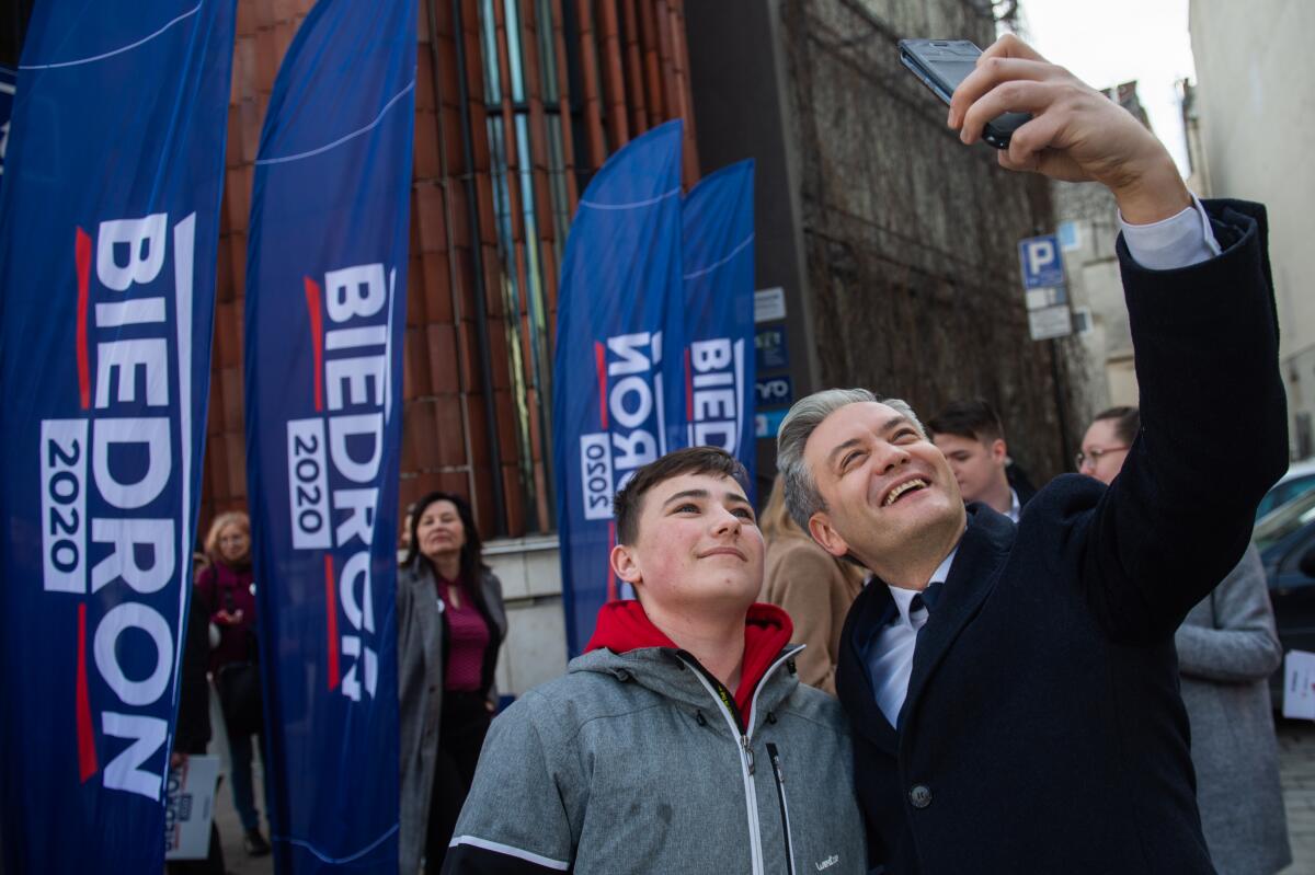 Robert Biedron takes a selfie with a supporter in the main square of  Krakow, Poland.