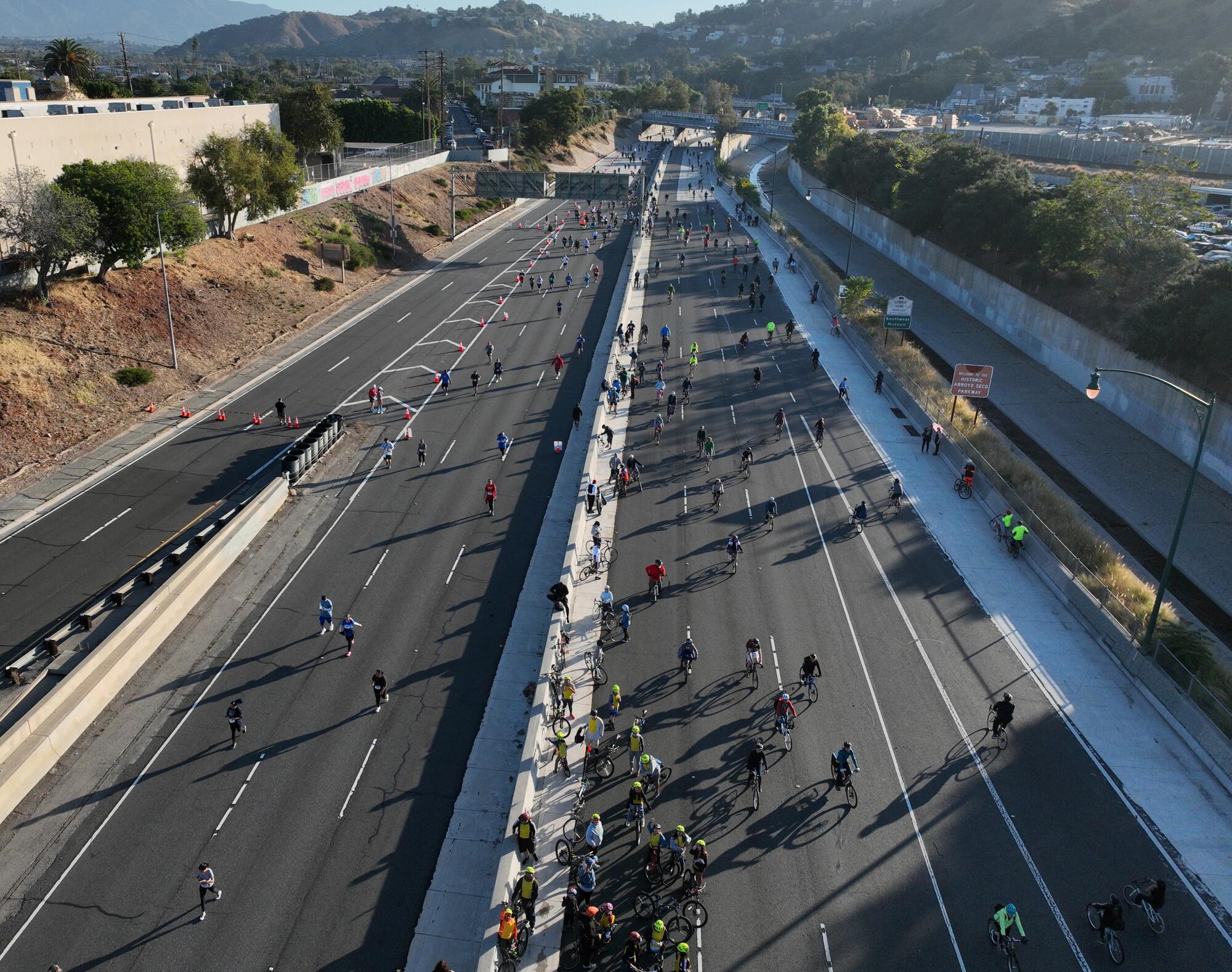 An aerial early morning view of bicyclists, rollerbladers, skateboarders, walkers and runners taking part in ArroyoFest.