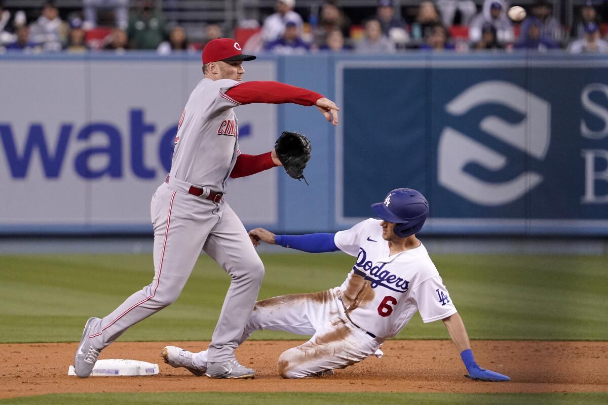 Dodgers baserunner Trea Turner is forced out at second as Cincinnati Reds second baseman Brandon Drury turns a double play.