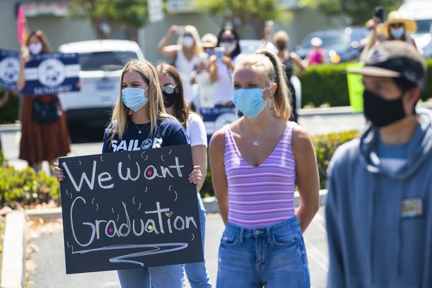 Students protest the Newport-Mesa Unified School District's decision to not hold in-person graduation ceremonies this year because of the COVID-19 pandemic outside of the school district office in Costa Mesa on Tuesday, May 26.