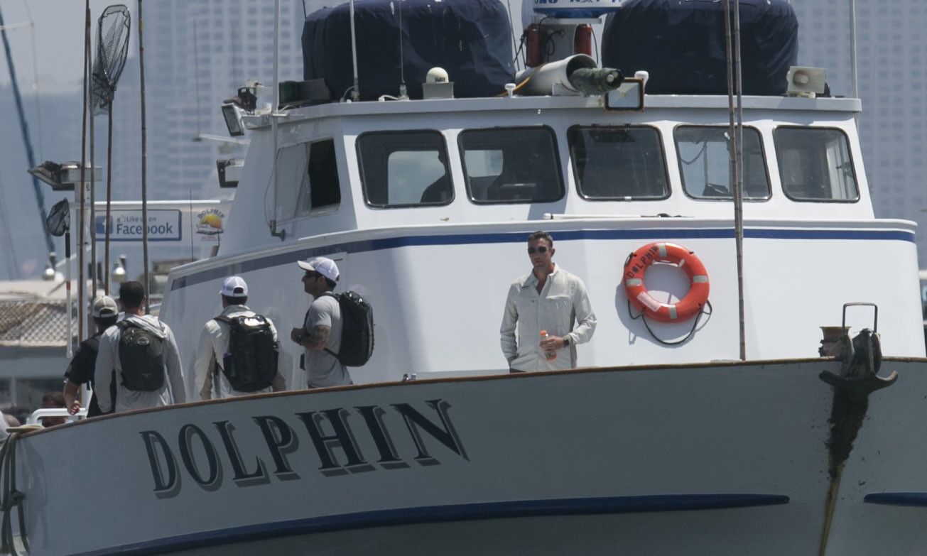 Duncan D. Hunter, right, on the bow of the fishing boat Dolphin as it came in to the landing.