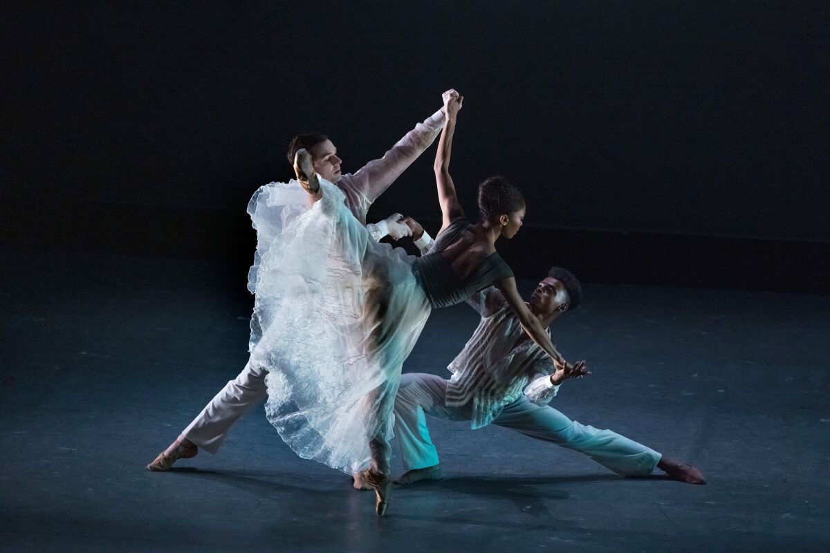 Ballet dancers on a dimly lit stage