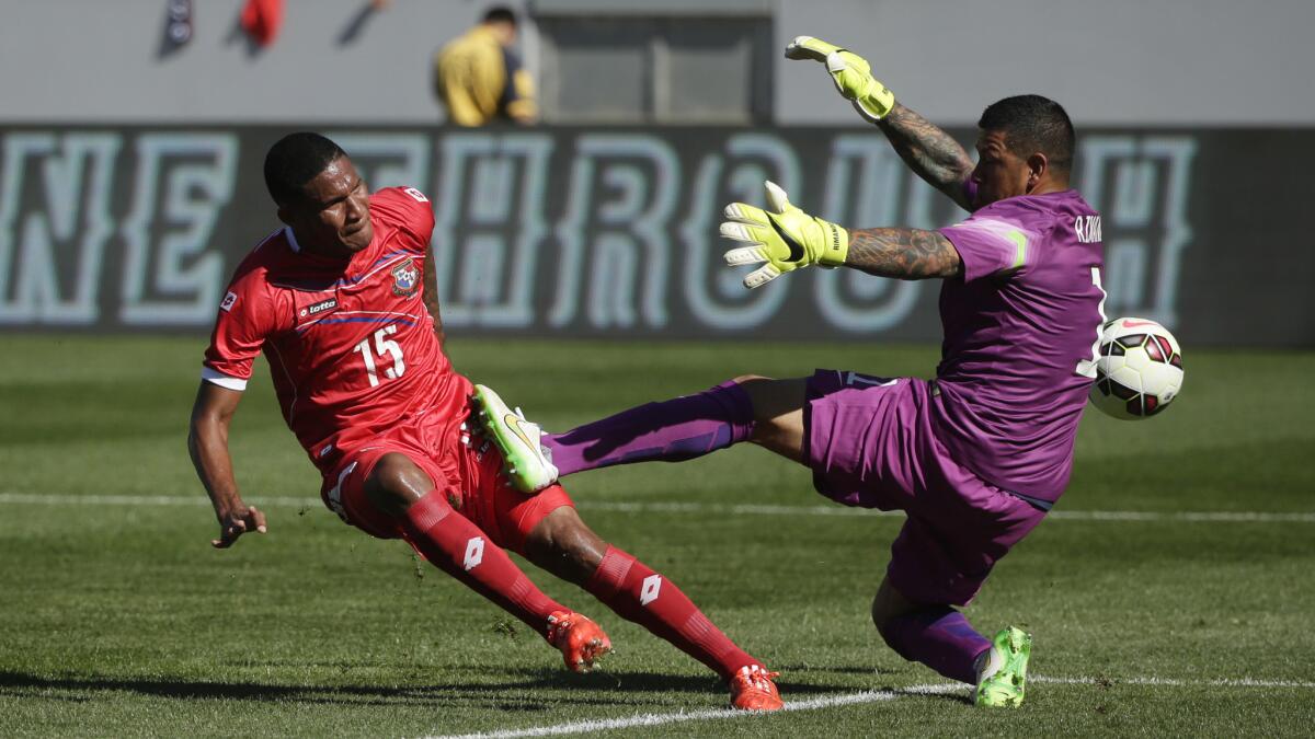 U.S. goalie Nick Rimando, right, deflects a shot by Panama's Eric Davis during the first half of an international friendly match at StubHub Center in Carson on Sunday. The U.S. won the match, 2-0.